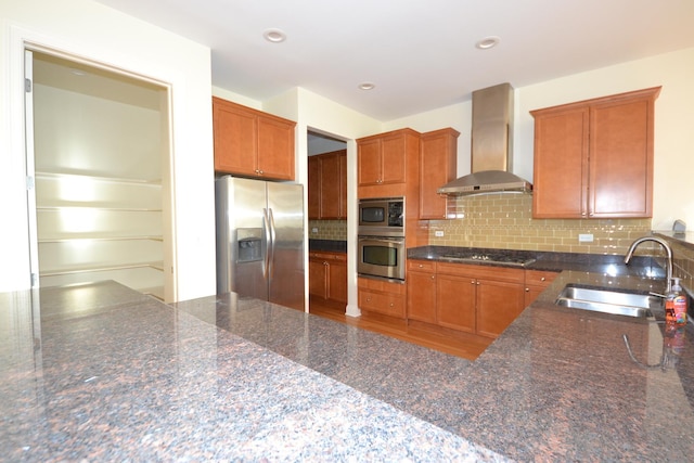 1416 S Emerald Ave, Chicago, IL 60607 - kitchen with wall chimney range hood, appliances with stainless steel finishes, a sink, backsplash, and dark stone counters