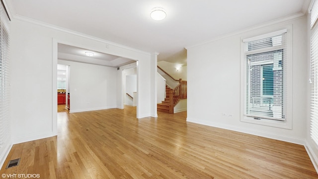 1416 S Emerald Ave, Chicago, IL 60607 - unfurnished room featuring light wood-type flooring, baseboards, ornamental molding, and stairs