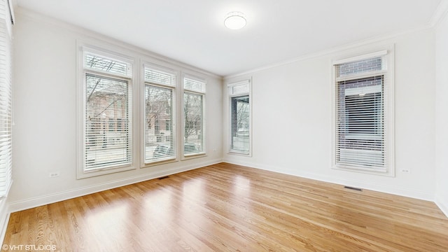 1416 S Emerald Ave, Chicago, IL 60607 - unfurnished room with light wood-type flooring, crown molding, and baseboards
