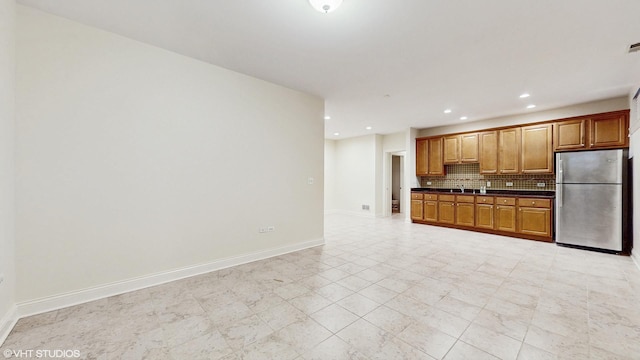 1416 S Emerald Ave, Chicago, IL 60607 - kitchen featuring freestanding refrigerator, dark countertops, backsplash, recessed lighting, and baseboards
