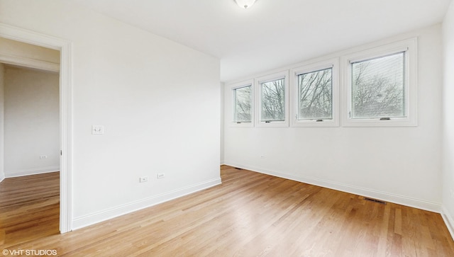 1416 S Emerald Ave, Chicago, IL 60607 - unfurnished room featuring baseboards and light wood-type flooring