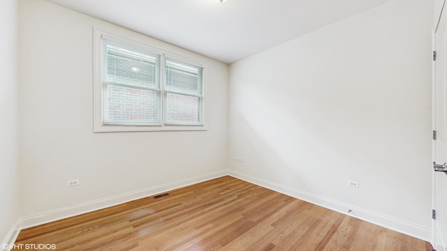 1416 S Emerald Ave, Chicago, IL 60607 - spare room with light wood-type flooring and baseboards