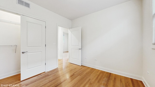 1416 S Emerald Ave, Chicago, IL 60607 - unfurnished bedroom featuring light wood-style floors, baseboards, and a closet