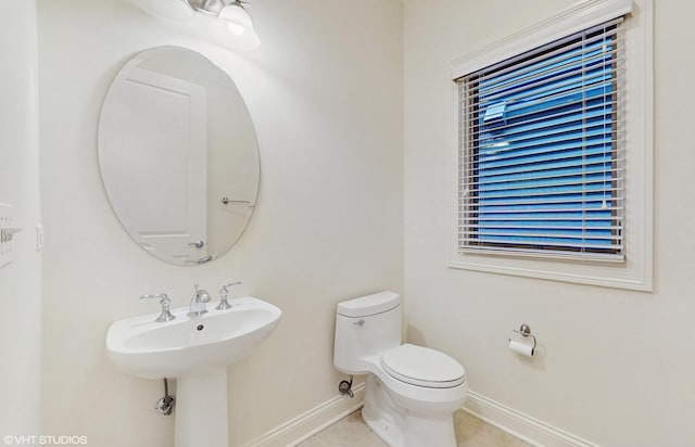 1416 S Emerald Ave, Chicago, IL 60607 - half bath featuring baseboards, tile patterned flooring, toilet, and a sink