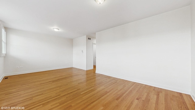 1416 S Emerald Ave, Chicago, IL 60607 - spare room with baseboards and light wood-style floors