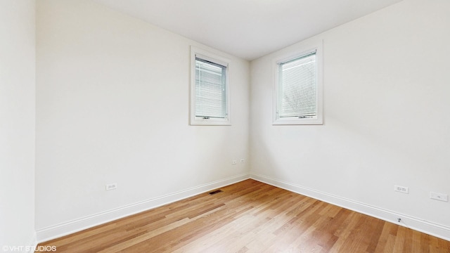 1416 S Emerald Ave, Chicago, IL 60607 - spare room featuring light wood-style flooring and baseboards