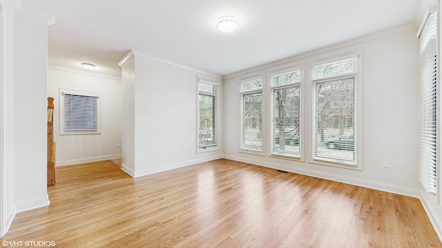 1416 S Emerald Ave, Chicago, IL 60607 - spare room with ornamental molding, light wood-style flooring, and baseboards