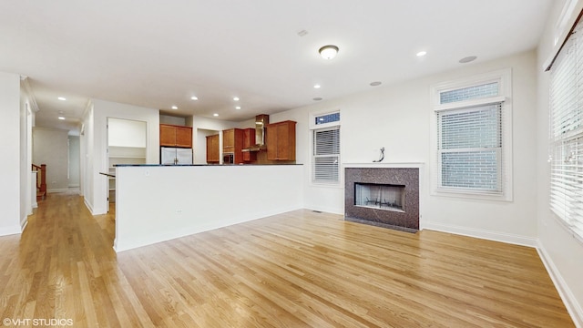 1416 S Emerald Ave, Chicago, IL 60607 - unfurnished living room featuring light wood-style flooring, baseboards, a fireplace with flush hearth, and recessed lighting