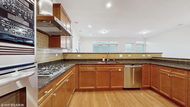 1416 S Emerald Ave, Chicago, IL 60607 - kitchen with a sink, stainless steel appliances, range hood, light wood-type flooring, and dark stone countertops
