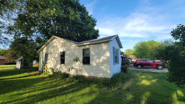 view of side of property with a yard