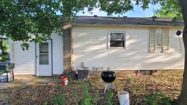 view of side of home with central AC unit