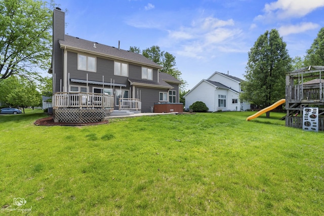 337 Aristocrat Dr, Bolingbrook, IL 60490 - back of house with a playground, a chimney, a yard, and a wooden deck