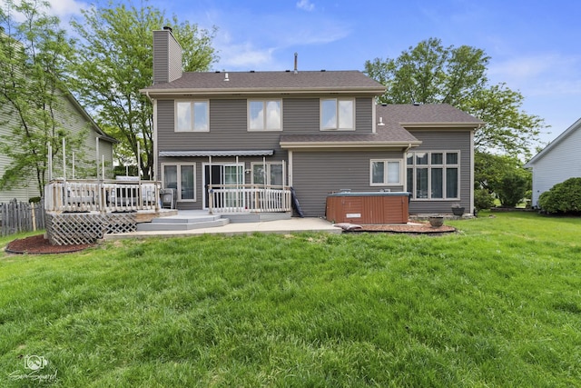 337 Aristocrat Dr, Bolingbrook, IL 60490 - back of property featuring a hot tub, a deck, a chimney, and a lawn