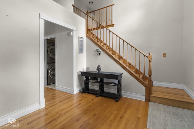 337 Aristocrat Dr, Bolingbrook, IL 60490 - staircase with stacked washer / dryer, wood finished floors, and baseboards