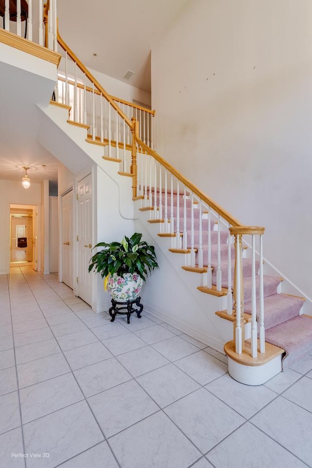 20825 Brookside Blvd, Olympia Fields, IL 60461 - staircase with tile patterned floors, a high ceiling, and baseboards