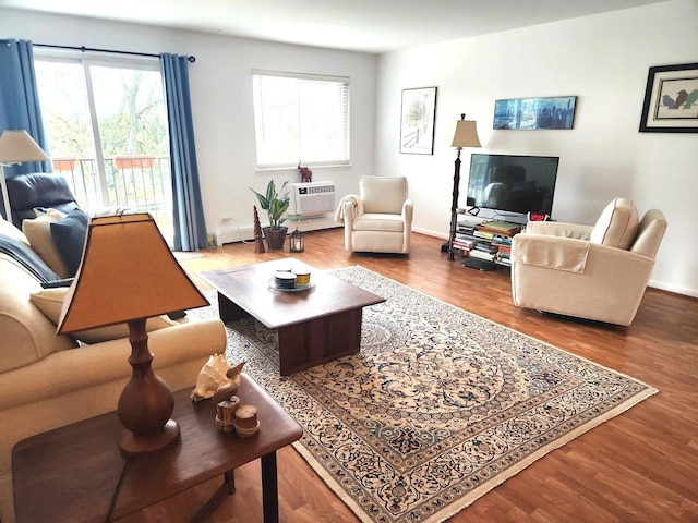 1001 N Mill St Unit 310, Naperville, IL 60563 - living area featuring wood finished floors, an AC wall unit, and baseboards