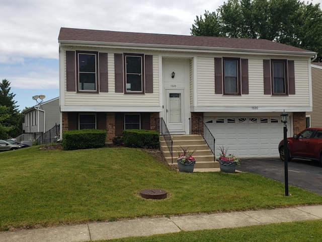 1020 Woodside Dr, Roselle, IL 60172 - bi-level home with driveway, a garage, brick siding, and a front yard