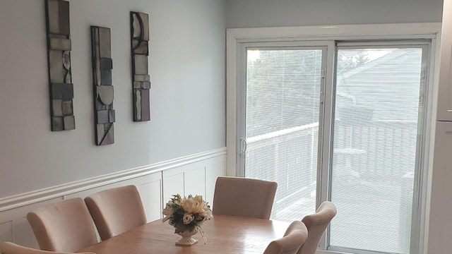 1020 Woodside Dr, Roselle, IL 60172 - dining area with plenty of natural light, wainscoting, and a decorative wall