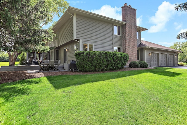 1224 Barclay Cir, Inverness, IL 60010 - view of side of home featuring a chimney, an attached garage, a lawn, a patio area, and driveway