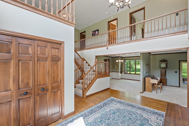 1224 Barclay Cir, Inverness, IL 60010 - carpeted foyer featuring a chandelier, a towering ceiling, stairs, wood finished floors, and baseboards