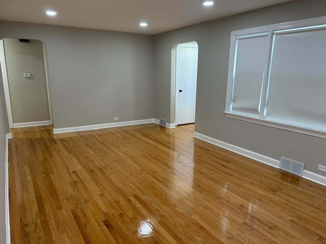 8841 Menard Ave, Morton Grove, IL 60053 - spare room with arched walkways, light wood-type flooring, recessed lighting, and baseboards