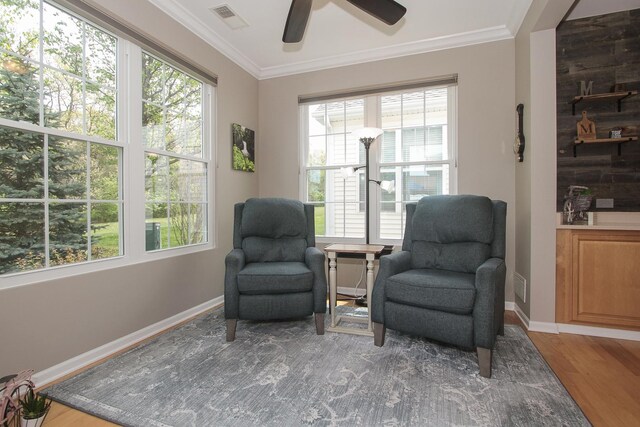 12370 Russet Ln, Huntley, IL 60142 - living area with ornamental molding, wood finished floors, a ceiling fan, healthy amount of natural light, and baseboards