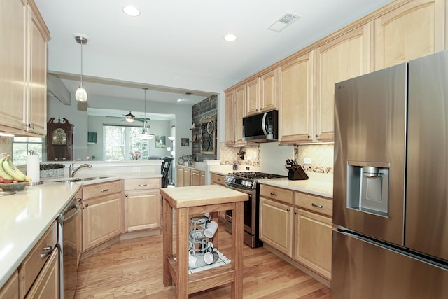 12370 Russet Ln, Huntley, IL 60142 - kitchen with stainless steel appliances, light brown cabinetry, a sink, light wood-type flooring, and recessed lighting