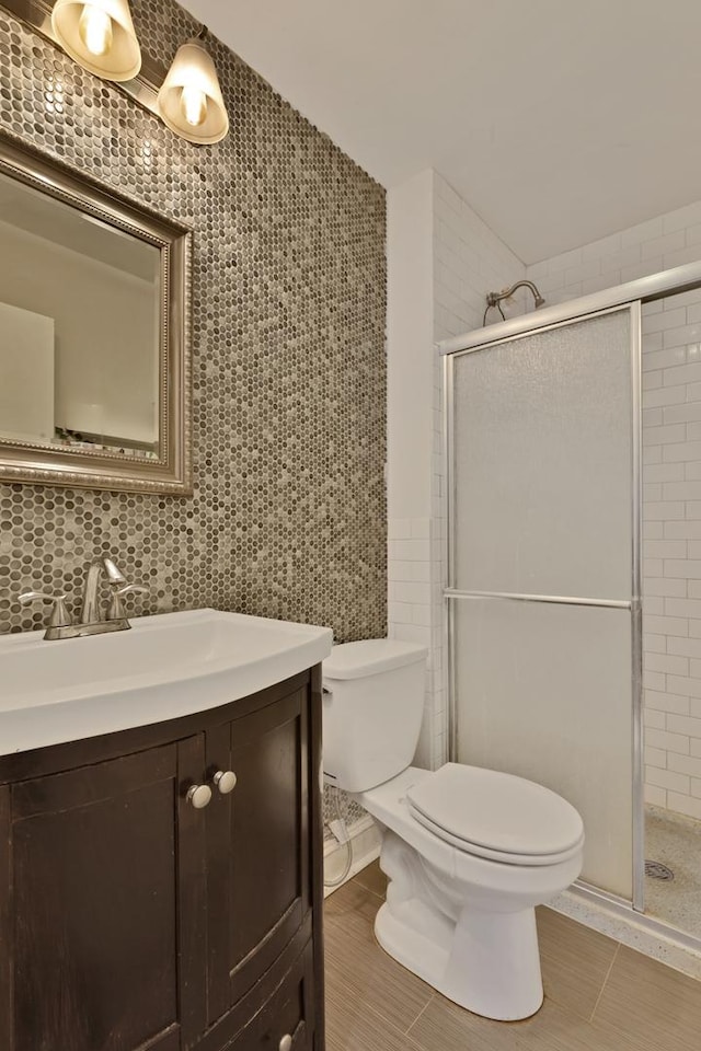 1640 W Sherwin Ave Unit 4D, Chicago, IL 60626 - bathroom featuring tile walls, a shower stall, toilet, vanity, and tile patterned flooring