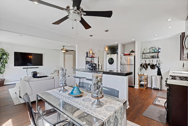 1640 W Sherwin Ave Unit 4D, Chicago, IL 60626 - dining room featuring stacked washer and clothes dryer, a ceiling fan, baseboard heating, dark wood-style floors, and recessed lighting