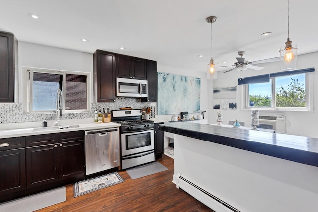 1640 W Sherwin Ave Unit 4D, Chicago, IL 60626 - kitchen with appliances with stainless steel finishes, decorative backsplash, dark wood-style floors, a baseboard radiator, and recessed lighting