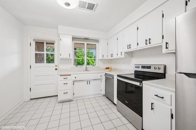 2222 Central St Unit 3, Evanston, IL 60201 - kitchen featuring stainless steel appliances, light countertops, white cabinetry, and a sink