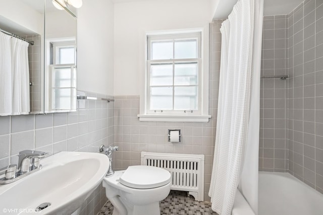 2222 Central St Unit 3, Evanston, IL 60201 - bathroom featuring radiator heating unit, a sink, toilet, shower / bath combination with curtain, and tile walls