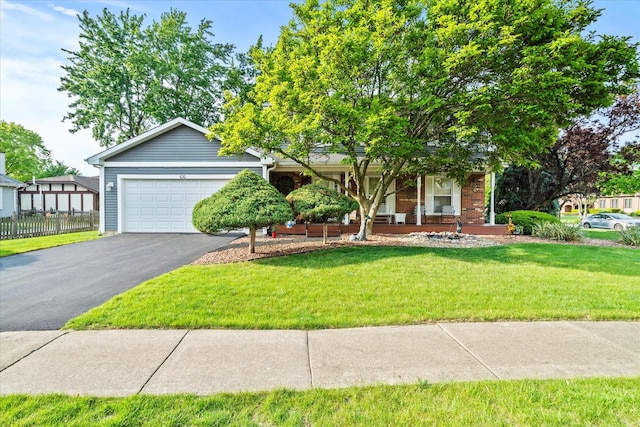 620 W 58th St, Westmont, IL 60559 - view of property hidden behind natural elements featuring asphalt driveway, an attached garage, and a porch