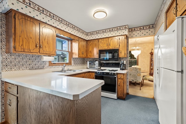 620 W 58th St, Westmont, IL 60559 - kitchen featuring freestanding refrigerator, black microwave, range with gas cooktop, a sink, and a peninsula