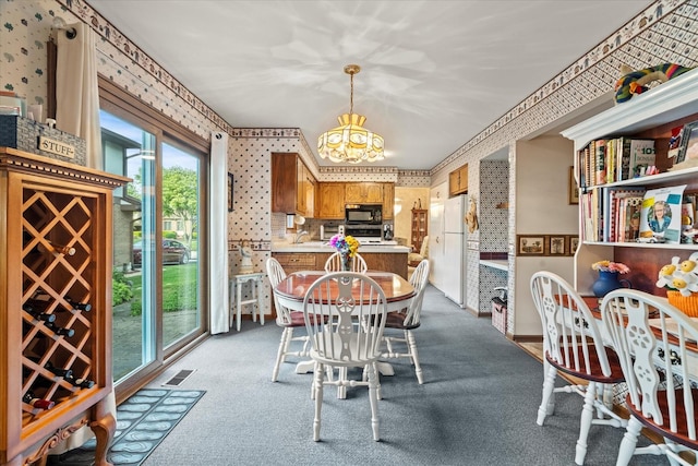 620 W 58th St, Westmont, IL 60559 - carpeted dining space featuring a chandelier, wallpapered walls, and a sink
