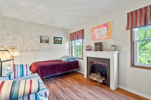 620 W 58th St, Westmont, IL 60559 - bedroom with wood finished floors, a fireplace, and baseboards
