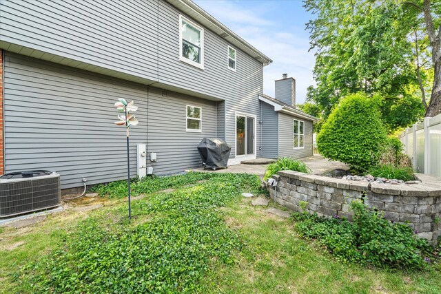 620 W 58th St, Westmont, IL 60559 - rear view of property with cooling unit, a chimney, and a patio area