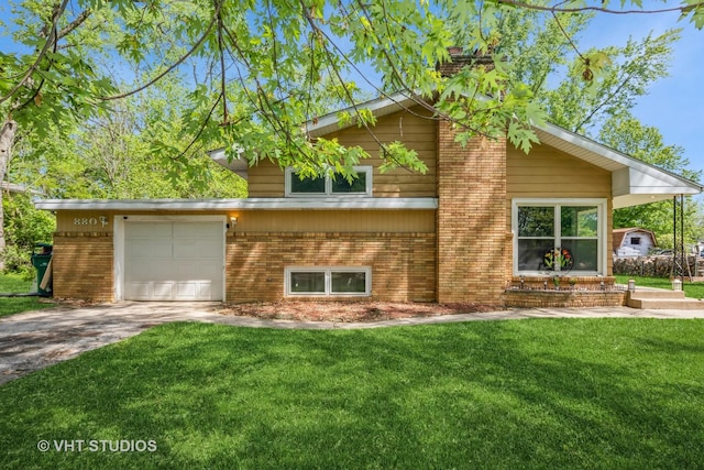 880 Marcella Rd, Merrillville, IN 46410 - view of front of home featuring brick siding, an attached garage, a front yard, and concrete driveway