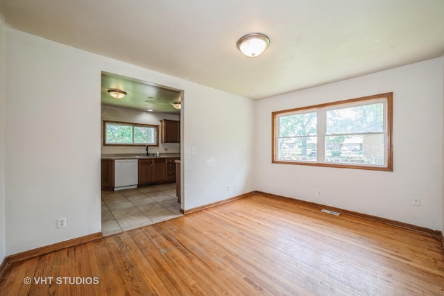 880 Marcella Rd, Merrillville, IN 46410 - unfurnished room featuring light wood-type flooring, a sink, and baseboards