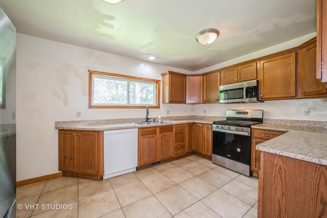 880 Marcella Rd, Merrillville, IN 46410 - kitchen with appliances with stainless steel finishes, a sink, and brown cabinetry
