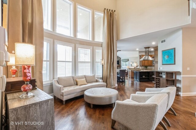 4111 Douglas Rd, Downers Grove, IL 60515 - living room featuring a towering ceiling, dark wood-style floors, and baseboards