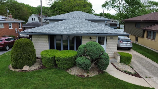 17121 Bernadine St, Lansing, IL 60438 - view of front of home with roof with shingles, brick siding, and a front yard
