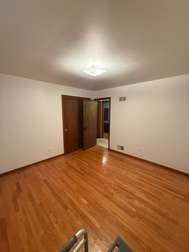 17121 Bernadine St, Lansing, IL 60438 - unfurnished bedroom featuring light wood-style floors, baseboards, and a closet