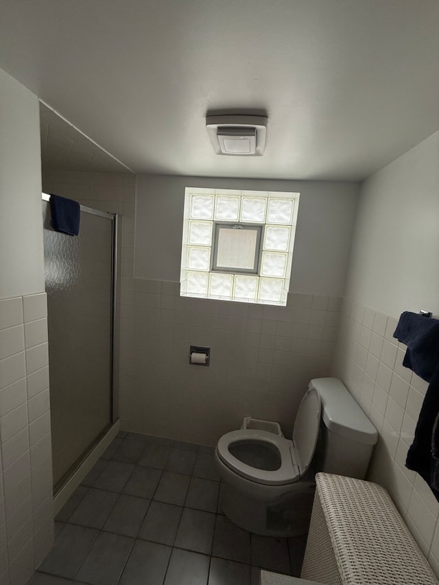 17121 Bernadine St, Lansing, IL 60438 - full bath with tile walls, a stall shower, toilet, tile patterned floors, and a wainscoted wall