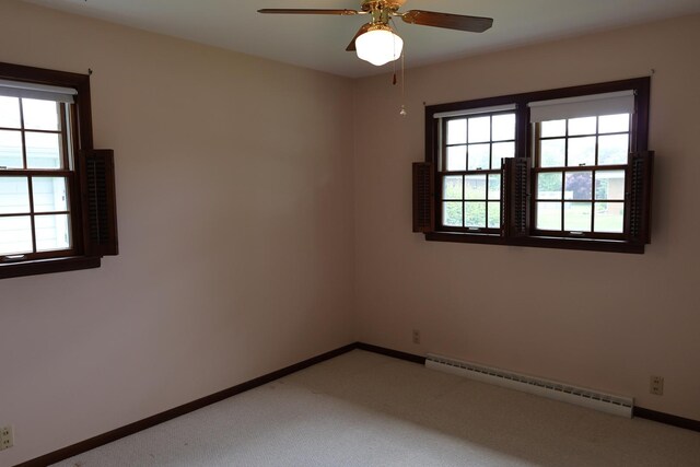 275 Hancock St, Clifton, IL 60927 - spare room featuring a baseboard heating unit, light carpet, ceiling fan, and baseboards