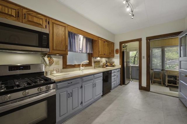 516 Clinton Ave, Oak Park, IL 60304 - kitchen featuring appliances with stainless steel finishes, light countertops, backsplash, gray cabinets, and brown cabinets