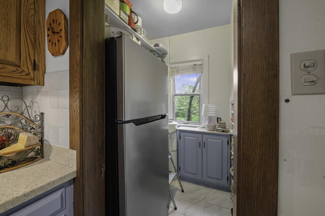 516 Clinton Ave, Oak Park, IL 60304 - kitchen featuring freestanding refrigerator, light countertops, and light marble finish flooring