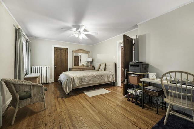 516 Clinton Ave, Oak Park, IL 60304 - bedroom featuring radiator heating unit, ornamental molding, wood finished floors, and a ceiling fan