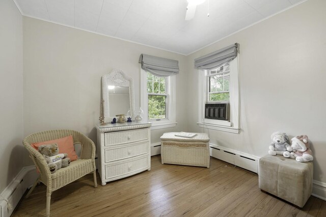516 Clinton Ave, Oak Park, IL 60304 - living area featuring baseboard heating, ornamental molding, cooling unit, and wood finished floors