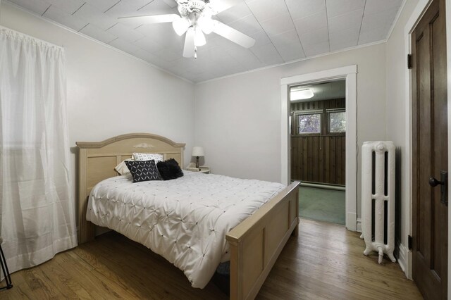 516 Clinton Ave, Oak Park, IL 60304 - bedroom featuring radiator heating unit, ornamental molding, wood finished floors, and ceiling fan